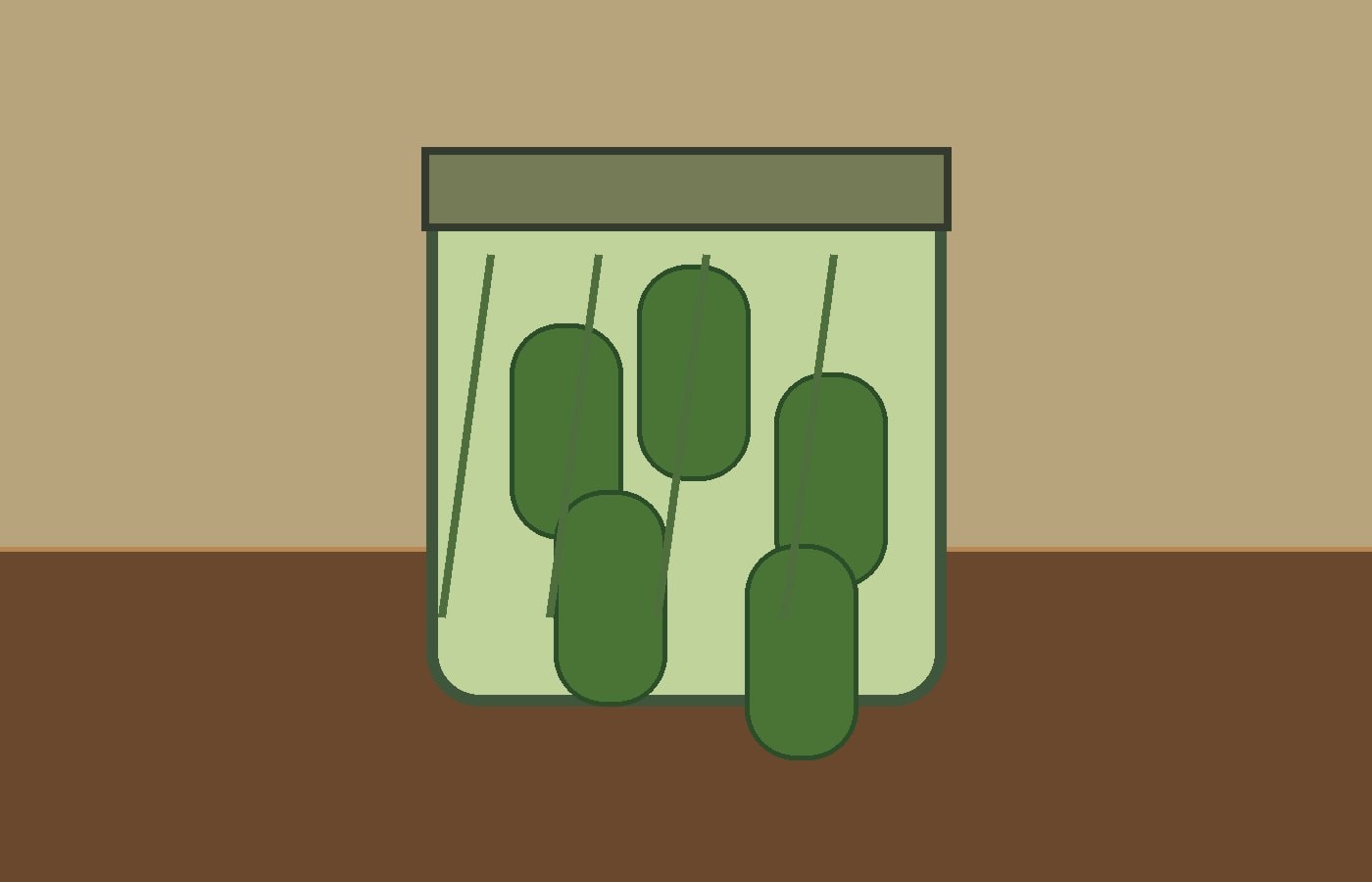 Glass jar of dill pickles beside fresh dill on a cream kitchen counter